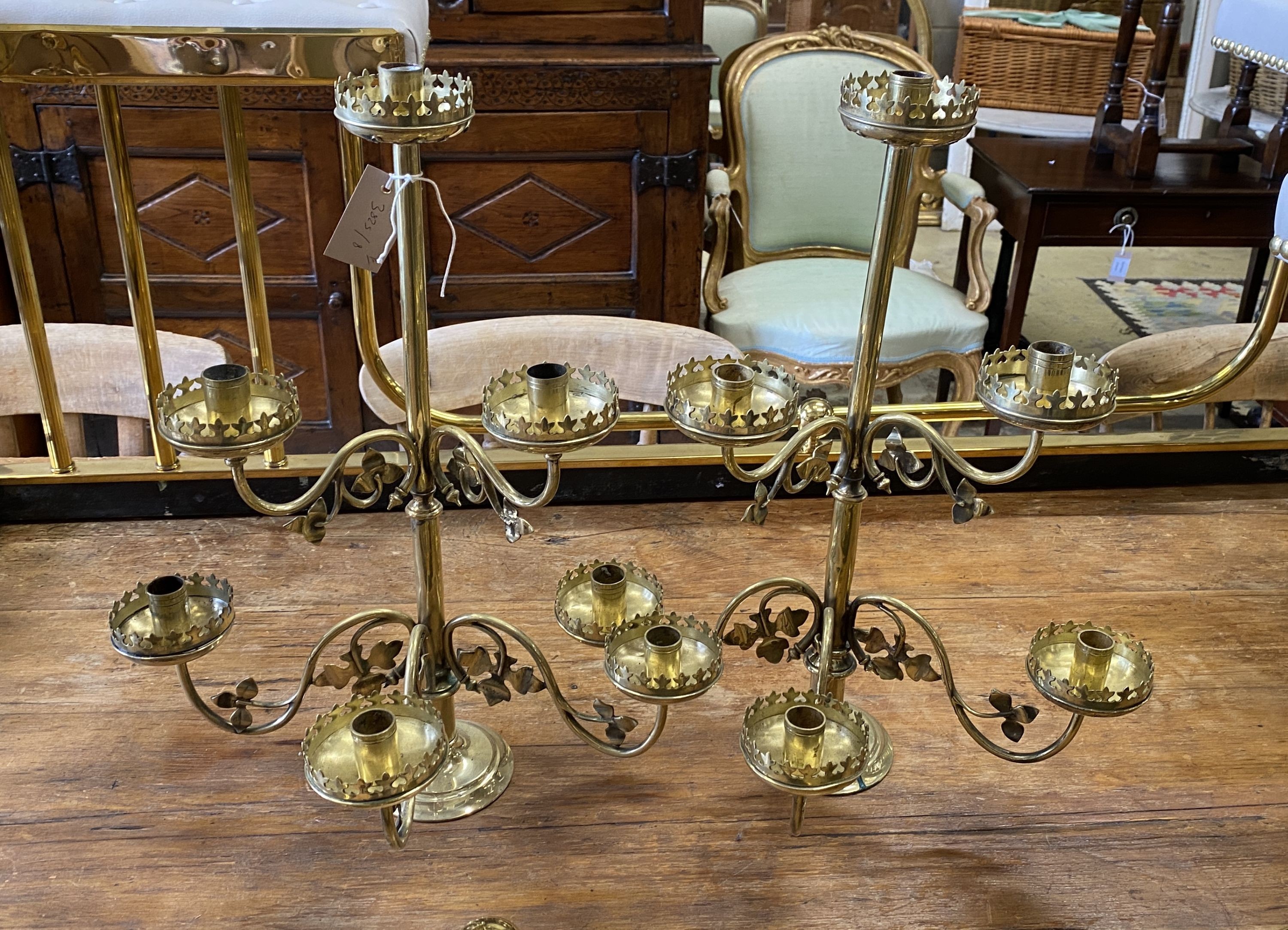 A pair of Victorian brass six branch candlesticks, height 52cm
